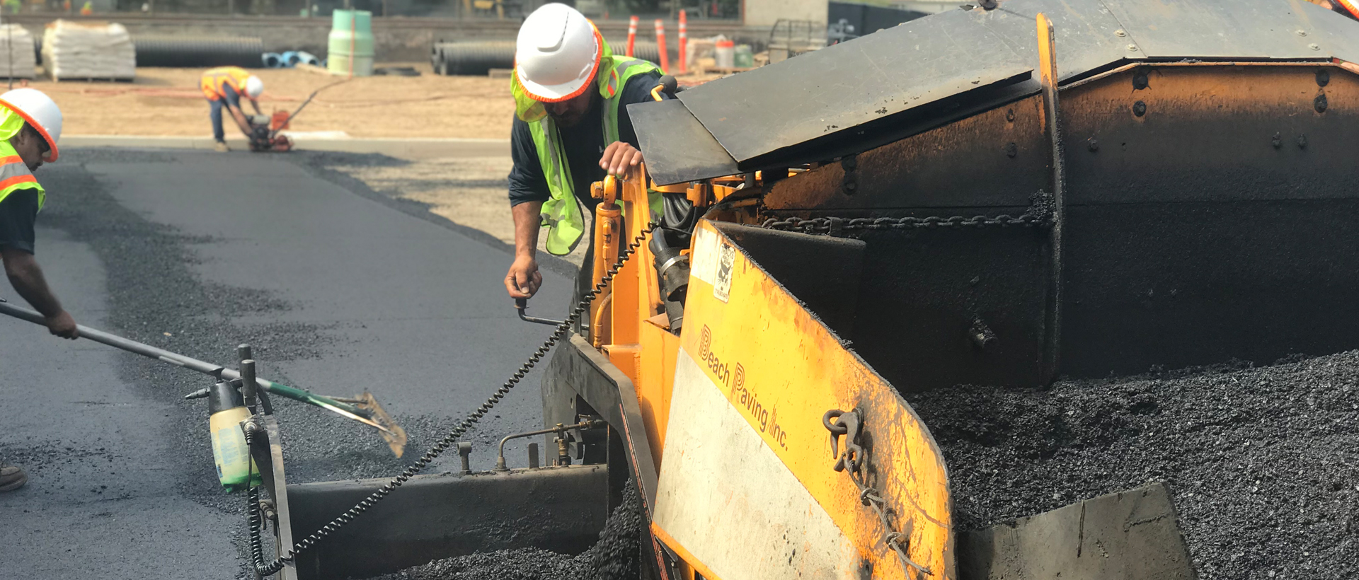 Close up of construction workers paving road