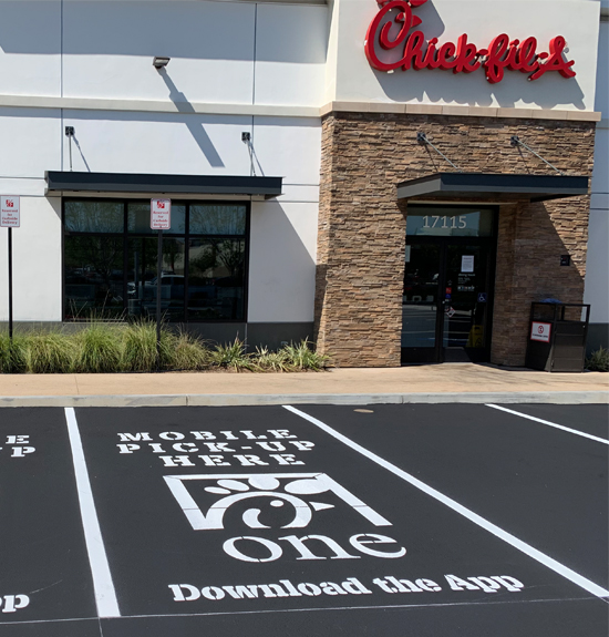 Exteror of a Chick-Fil-A shows newly paved and striped parking spaces.